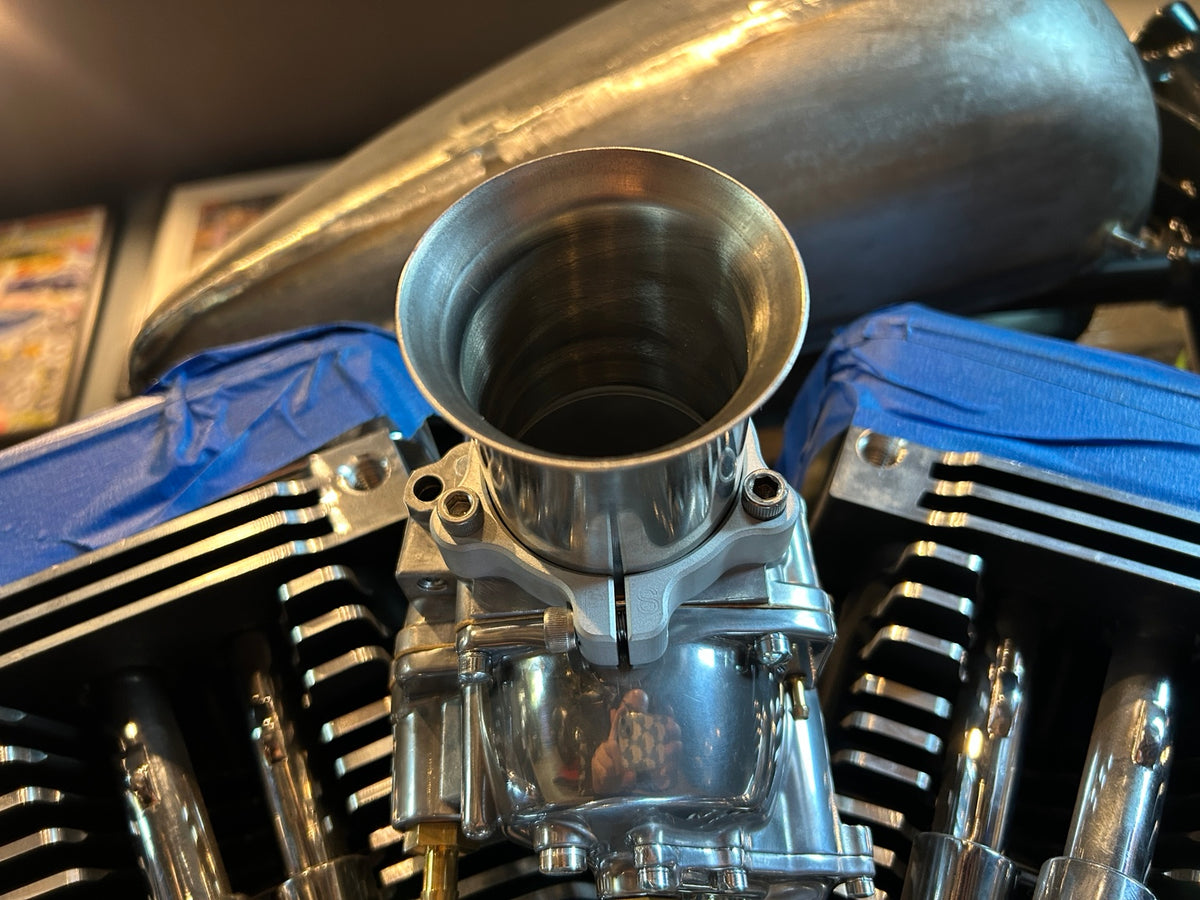 Pangea Speed adjustable velocity stack installed on a motorcycle carburetor, front view