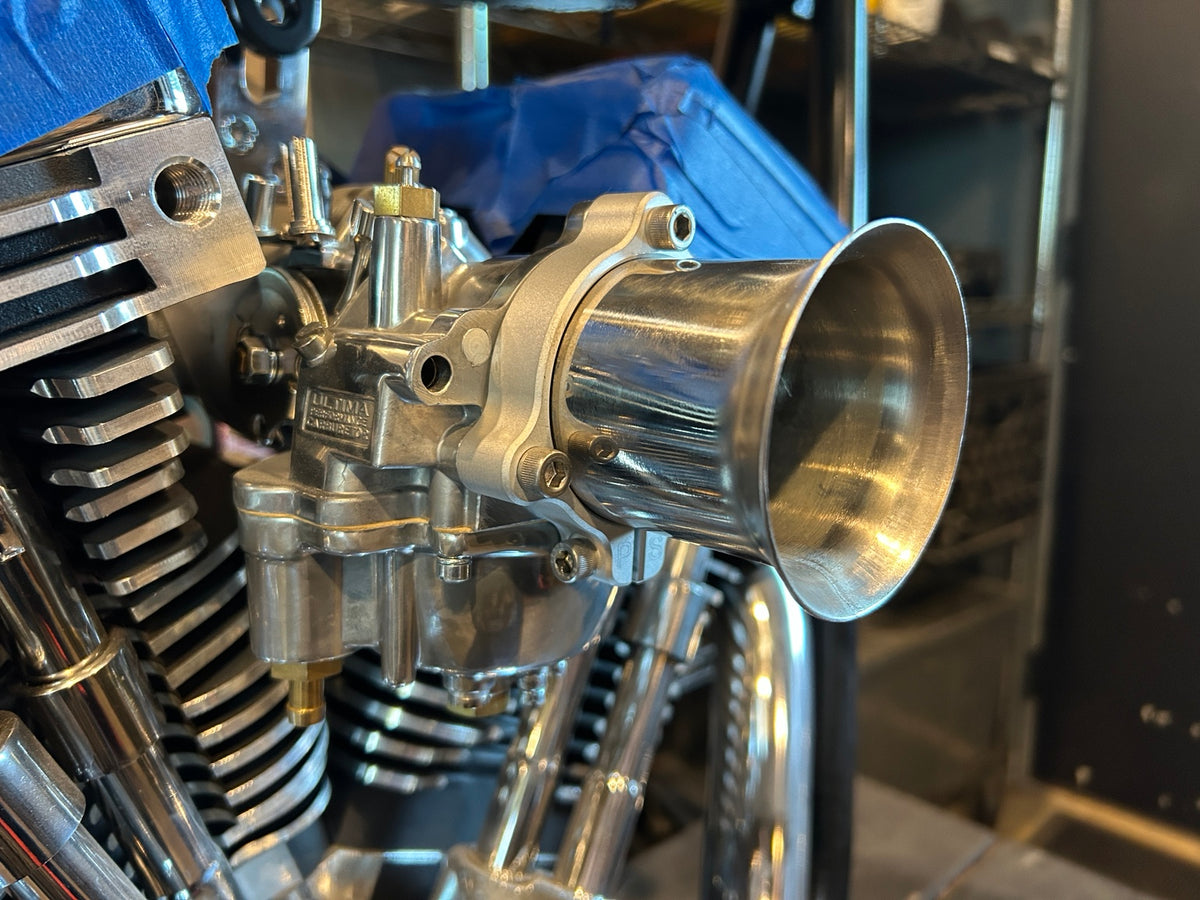 Pangea Speed adjustable velocity stack installed on a motorcycle carburetor, side view